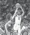  ?? BEN QUEEN/USA TODAY SPORTS ?? West Virginia guard Taz Sherman shoots against Connecticu­t on Wednesday in Morgantown, W. Va.