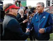  ?? CURTIS COMPTON / CCOMPTON@AJC.COM ?? Coaches Kirby Smart and Paul Johnson shake hands after the Bulldogs’ win.