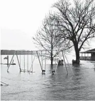  ?? JIM SALTER/AP ?? A playground is submerged in Clarksvill­e, Mo., a town that is suffering its seventh major flood in the past decade.
