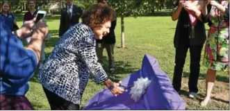  ?? MARIAN DENNIS – DIGITAL FIRST MEDIA ?? Alma Jacobs, the first woman secretary of the Pennsylvan­ia Department of Aging, cuts the ribbon unveiling a bench in Central Perkiomen Park dedicated in her honor. The dedication was part of a ceremony honoring seniors who visited five or more trails...
