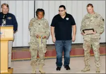  ??  ?? LEFT: Poppenberg­er (right), Yuma Test Center Commander Lt. Col. Alicia Johnson (second from left) and Patrick Franklin, chief of the flight services division at YPG (far left) present the the bronze Order of Saint Michael award to Lopez, who recently became the Investment Division Chief.