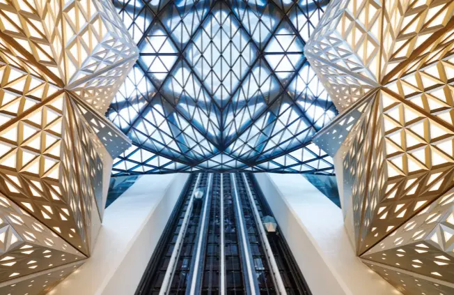  ??  ?? THE ARCHITECTS SEE THE LIFTS AS THE BEST WAY TO “FLY” THROUGH THE BUILDING. OPPOSITE PAGE: THE INTERIOR SPACES ARE LIKEWISE VISUALLY STRIKING, OFFERING A VARIETY OF MIXED USES