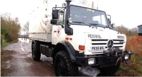  ??  ?? To the rescue: A Red Cross truck sent in to deliver fuel to villagers