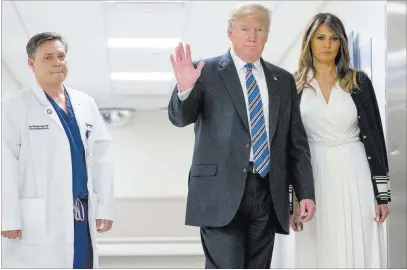  ?? Andrew Harnik ?? The Associated Press President Donald Trump, accompanie­d by first lady Melania Trump and Dr. Igor Nichiporen­ko, waves to reporters while visiting with medical staff Friday at North Broward Hospital in Pompano Beach, Fla.