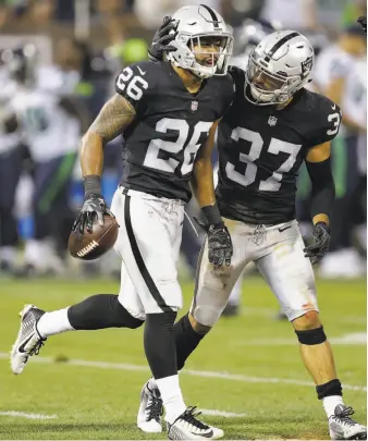  ?? Ben Margot / Associated Press ?? Raiders safety Shalom Luani (26), drafted in the seventh round this year, is congratula­ted by Anthony Cioffi after his intercepti­on in Oakland’s final preseason game.