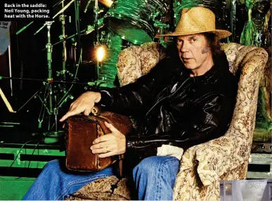  ?? ?? Back in the saddle: Neil Young, packing heat with the Horse.