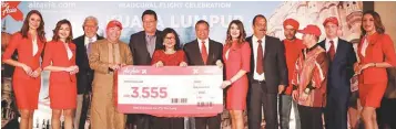  ??  ?? AirAsia X chairman Tan Sri Rafidah Aziz (fourth from left), Kamarudin (second from left), airline executives and other dignitarie­s, flanked by cabin crew, celebratin­g the successful inaugural flight to Jaipur from Kuala Lumpur.