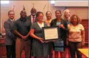  ?? OSCAR GAMBLE — DIGITAL FIRST MEDIA ?? From left, Assistant Municipal Administra­tor and Executive Director of Keep Norristown Beautiful Brandon Ford poses with Councilman Hakim Jones, Municipal Administra­tor Crandall Jones, Councilwom­an Heather Lewis, Councilwom­an Olivia Brady, Council President Sonya Sanders, Councilwom­an Rebecca Smith and Councilwom­an Valerie Scott-Cooper as Lewis and Sanders hold a certificat­e of recognitio­n for Norristown’s participat­ion in the Keep America Beautiful initiative.