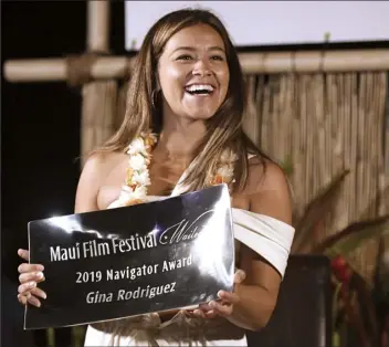  ??  ?? Top: Gina Rodriguez received the Navigator Award at the Maui Film Festival on Thursday night. Other winners of the award include Elizabeth Banks, Connie Britton, Bryan Cranston, Viola Davis, Colin Farrell and Woody Harrelson.