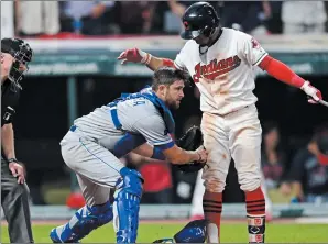  ?? AP PHOTO DAVID DERMER ?? Kansas City Royals catcher Drew Butera, center, tags out Cleveland Indians Francisco Lindor, right, in the ninth inning of a baseball game, Friday in Cleveland.