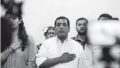  ?? ALFREDO ZUNIGA AP ?? Nicaraguan opposition activist Felix Maradiaga, center, stands at attention during the national anthem at a 2019 press conference in Managua.