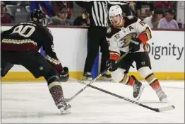  ?? DARRYL WEBB — THE ASSOCIATED PRESS ?? The Ducks' Troy Terry, right, looks for an opening against J.J. Moser of the Arizona Coyotes during the second period of Saturday afternoon's game in Tempe, Ariz.