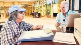  ?? SUSAN STOCKER/STAFF PHOTOGRAPH­ER ?? Jane Speiser, 84, left, is assisted by counselor Jolyon King with her Medicare enrollment at the Southwest Senior Focal Point Center in Pembroke Pines.