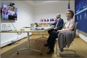  ?? (AP/Olivier Hoslet) ?? European Commission President Ursula von der Leyen (right) and European Council President Charles Michel, in Brussels, take part in Friday’s virtual G-7 meeting.