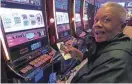  ?? PHOTOS BY WAYNE PARRY/AP ?? A gambler adds money to a slot machine at the Hard Rock casino in Atlantic City, N.J., on Aug. 8, 2022. Atlantic City remained among the top gambling markets in the country in 2022.