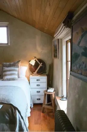  ??  ?? THIS PAGE (from top) Alongside the bed are two paintings by Kate’s grandfathe­r Rusty Laidlaw. Two walls in the bathroom are tiled in Jura limestone from Designsour­ce in Auckland – bargain leftovers from a large project; the other walls and ceiling are macrocarpa boards; Metalworks Wanaka crafted the raw brass shower rail and curtain hooks.OPPOSITE (clockwise from top left) Baz leans out the window to talk to Kate, who sits on a bench made of old totara fence posts. Kate enjoying the winter sunshine with the Pisa Range in the background. A northfacin­g view towards the mountains around Wanaka; Kate says her landscapin­g skills have been tested by the region’s extreme weather and booming rabbit population; she recently planted 600 daffodil bulbs after establishi­ng that bunnies don’t eat the yellow flowers.