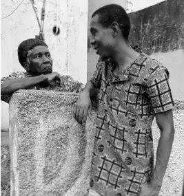  ??  ?? Jermaine Cowie greeting an elderly West Kingston resident.