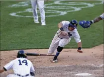  ?? ADAM HUNGER - THE ASSOCIATED PRESS ?? New York Yankees’ Mike Tauchman scores the game winning run under a tag attempt by New York Mets catcher Wilson Ramos during the eighth inning of the first baseball game of a doublehead­er, Sunday, Aug. 30, 2020, in New York. The Yankees won 8-7.