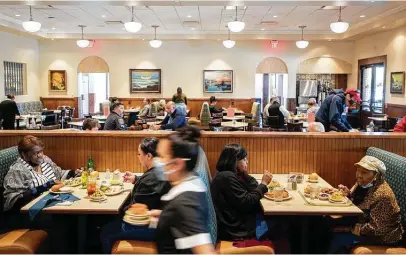  ?? Godofredo A. Vásquez / Staff photograph­er ?? Customers eat lunch at Cleburne Cafeteria in Houston last week. Its March sales are up 20 percent from the previous month.