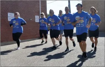  ?? ?? First responders from police, fire and ambulance services in Swift Current jog around the Swift Current Fire Hall in support of the 3rd annual Superhero Walk Wheel Run, Sept. 23.