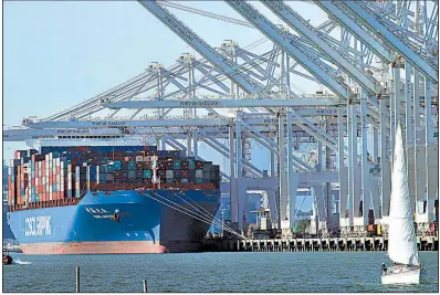  ?? AP file photo ?? A container ship waits to be unloaded in January at the Port of Oakland in California. The Commerce Department reported Wednesday that the U.S. economy’s rate of growth slowed in the last three months of 2017.