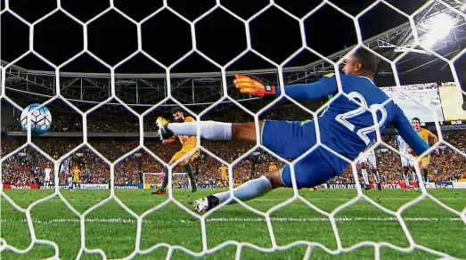  ??  ?? Back of the net: Australia’s Mile Jedinak scoring his hattrick from a penalty at the ANZ Stadium in Sydney yesterday. — Reuters