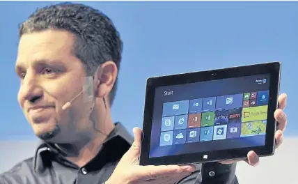  ?? AFP ?? Panos Panay, corporate vice president of Microsoft Corp, holds the Surface 2 during a news conference in New York on Monday.