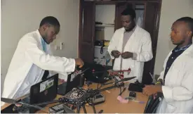  ??  ?? Engineers at Cameroon’s Will & Brothers work on a drone at a workshop in Douala. The start-up hopes to become a big player in the drone market