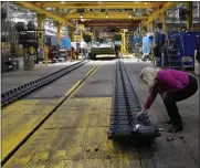  ?? ?? Wormuth touches the treads of the M1A2 Abrams main battle tank during a tour of the manufactur­ing center.