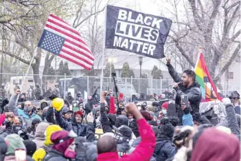  ?? — AFP ?? A community leader speaks as protesters rally outside the Brooklyn Center police station to protest the death of Daunte Wright who was shot and killed by a police officer in Brooklyn Center, Minnesota on Tuesday.