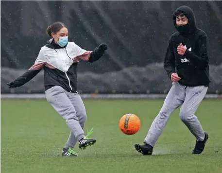  ?? MATT sTonE pHoTos / HErAld sTAFF FilE ?? PLAYING SOCCER: Co-ed team members Lisette Perez and Leonel Garcia play soccer during a practice session at the Greater Lawrence Technical School in Andover on March 18. Below, Lukas Wilson and Kaylie Ortiz play.