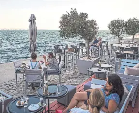  ??  ?? Aristotelo­us Square, above, is the main city square of Thessaloni­ki. The industrial-chic Kitchen Bar is situated on a pier with sweeping views of the Aegean Sea.