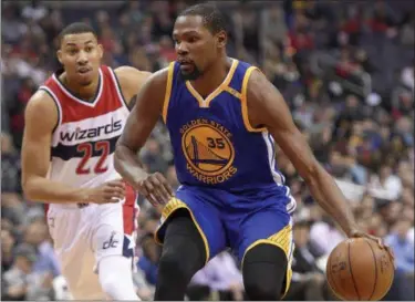  ?? NICK WASS — THE ASSOCIATED PRESS ?? Golden State Warriors forward Kevin Durant (35) dribbles the ball past Washington Wizards forward Otto Porter Jr. (22) during the first half on Feb. 28 in Washington.