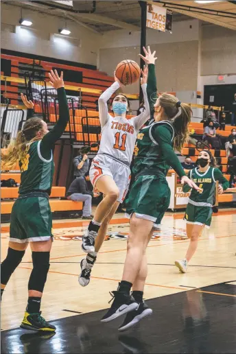  ?? NATHAN BURTON/Taos News ?? The Lady Tigers Madelynn Quintana shoots the ball during a home game against Los Alamos on Saturday (Jan. 29).