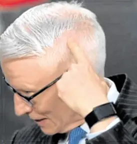  ??  ?? CNN’S Anderson Cooper points at his haircut fail during live broadcast.