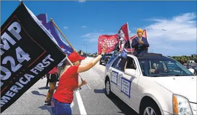  ?? Evan Vucci Associated Press ?? SUPPORTERS OF former President Trump gather outside his Mar-a-Lago residence in Florida on Sunday.