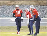  ?? Steven Senne / Associated Press ?? New England Patriots quarterbac­ks, from left, Tom Brady (12), Brian Hoyer and Danny Etling warm up during practice on Wednesday in Foxborough, Mass.