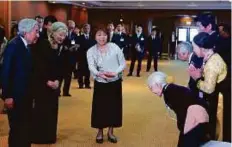  ?? AFP ?? Nguyen Thi Xuan, 92, who married a former Japanese soldier, greets Emperor Akihito (left) and Empress Michiko in Vietnam.