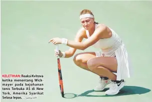  ?? — Gambar AFP ?? KELETIHAN: Reaksi Kvitova ketika menentang Wickmayer pada kejohanan tenis Terbuka AS di New York, Amerika Syarikat Selasa lepas.