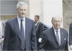  ??  ?? 0 France’s Bruno Le Maire, left, with Wilbur Ross