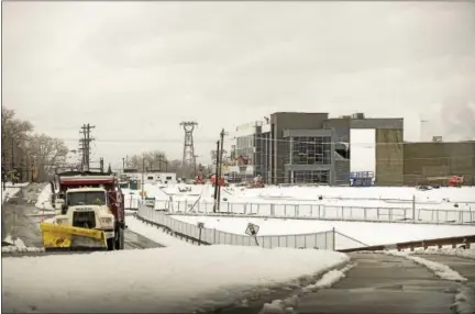  ?? RICK KAUFFMAN — DIGITAL FIRST MEDIA ?? Snow is plowed Tuesday outside the new center for the Chester Charter School for the Arts along Highland Avenue in Chester. The $25 million project has moved swiftly and is scheduled to open in 2018 with a full K-12 and 750 enrolled students.