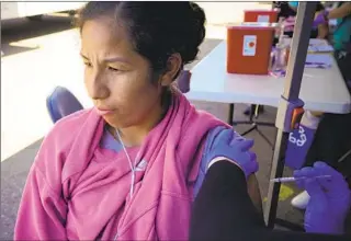  ?? NELVIN C. CEPEDA U-T ?? Nancy Vidal receives her first dose of the COVID-19 vaccine at a mobile clinic in City Heights on Saturday. Vidal had COVID in 2021 and said that she was nervous to get the vaccine.