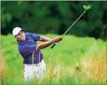  ?? Stuart Franklin Getty Images ?? HAROLD VARNER III hits out of the rough on the fourth hole on the way to an 11-over-par 81 at the PGA Championsh­ip.