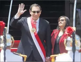  ?? Karel Navarro Associated Press ?? MARTIN VIZCARRA, with his wife, greets the crowd in Lima after he is sworn in as Peru’s new president. His predecesso­r resigned amid charges of vote-buying.