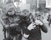  ?? FERNANDO VERGARA AP ?? Riot police detain a student who was protesting against the government during a national strike in Bogota on Dec. 10. The student was part of a protest whose demands include asking President Ivan Duque to not make changes in the tax, labor and pension laws that are either before the legislatur­e or rumored to be in developmen­t.