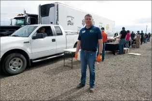  ?? NEWS PHOTO GILLIAN SLADE ?? Steven Dyck, president Western Tractor, stands by the convoy of vehicles arriving for a bag of McCain frozen french fries and then making donations to HALO helicopter medevac organizati­on, on Friday morning.