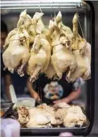  ??  ?? Boiled chickens sit ready to be put into a dish at a food stall in the Silom area of Bangkok.