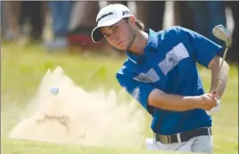  ?? The Associated Press ?? Canada’s Austin Connelly chips out of the bunker on the first hole during the final round of the British Open at Royal Birkdale in Southport, England, on Sunday.