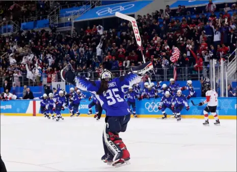  ??  ?? The United States players celebrate winning after the women’s gold medal hockey game against Canada at the 2018 Winter Olympics in Gangneung, South Korea, on Thursday. AP PHOTO