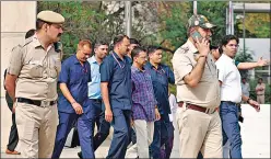  ?? REUTERS ?? Police officers escort Chief Minister of Delhi and Aam Aadmi Party (AAP) chief Arvind Kejriwal as he leaves the court after a hearing in New Delhi.